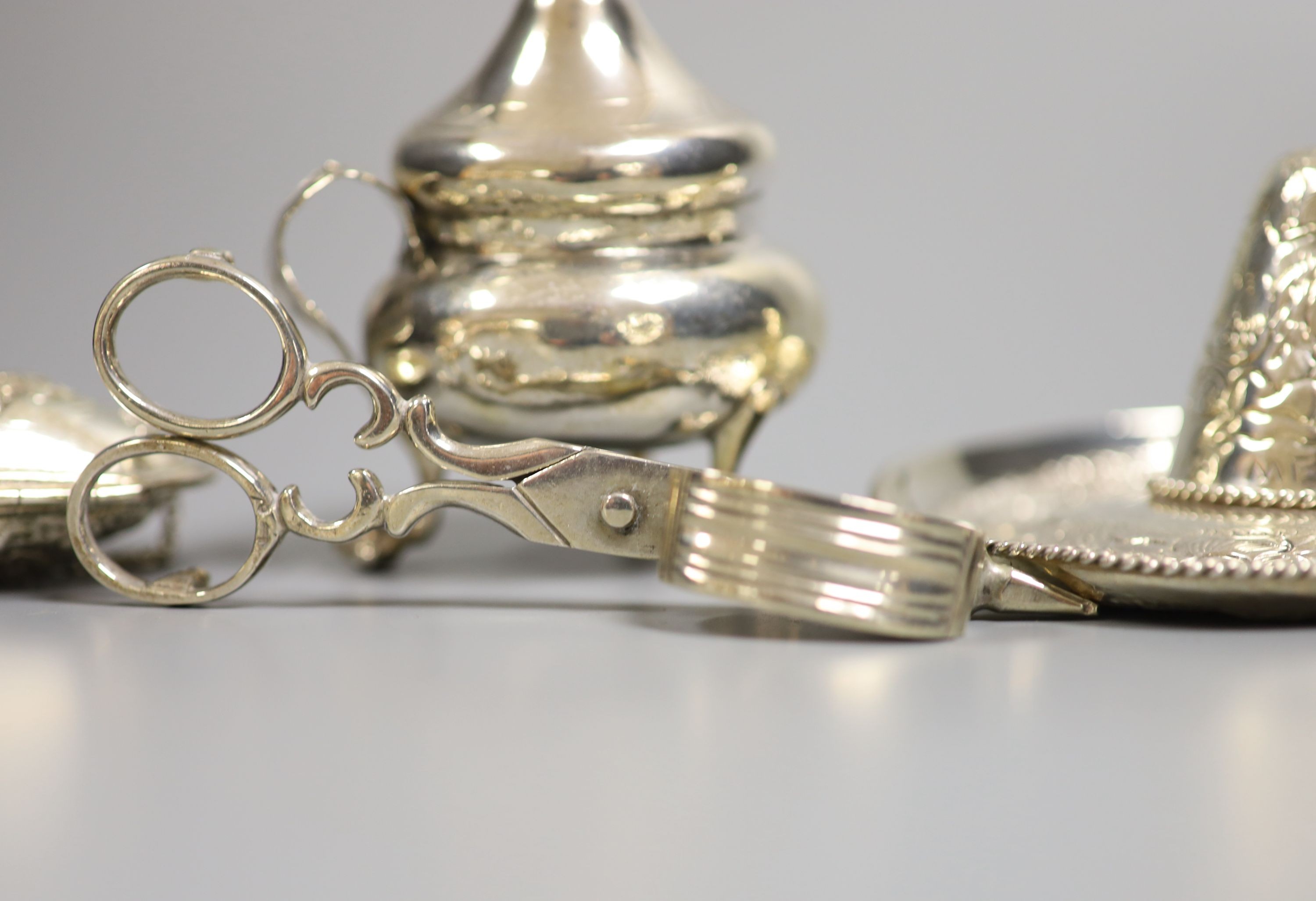 A sterling miniature sombrero and three other items, including candle snuffers and purse